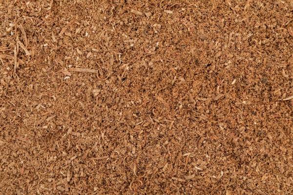 Close-up of fine golden-brown coco peat, the processed pith of the coconut husk
